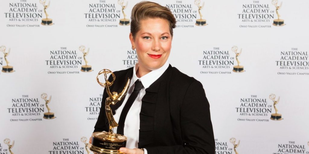 Jennifer Zmuda holding an Emmy Award at The National Academy of Television Arts & Sciences Ohio Valley Chapter.