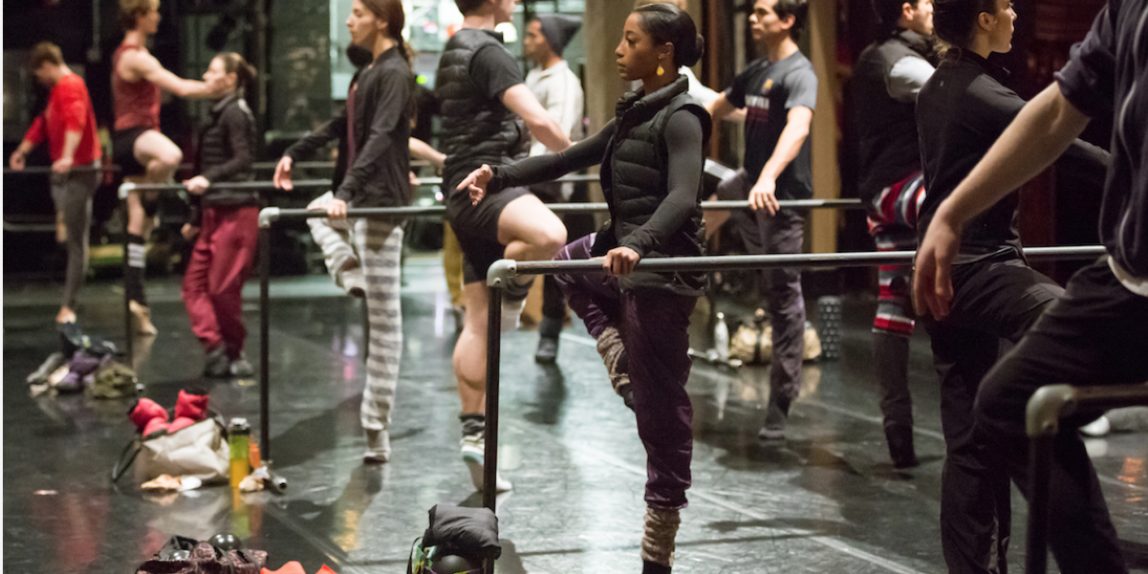 A group of ballerinas in a ballet class.