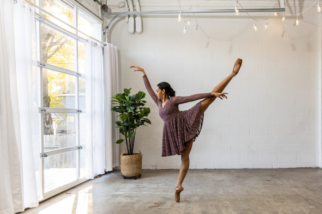 Black dancer in an arabesque at Zurie Studios, dance photographer